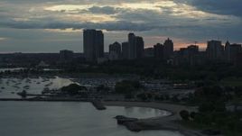 5.7K aerial stock footage of skyscrapers in the city's skyline seen from the marina at sunset, Downtown Milwaukee, Wisconsin Aerial Stock Footage | DX0002_155_020