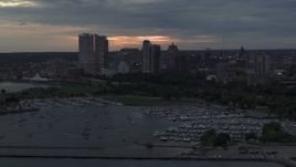 5.7K aerial stock footage of skyscrapers in the city's skyline seen while ascending near marina at twilight, Downtown Milwaukee, Wisconsin Aerial Stock Footage | DX0002_155_025
