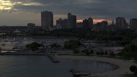 5.7K aerial stock footage of descending by the marina with a view of the city's skyline at twilight, Downtown Milwaukee, Wisconsin Aerial Stock Footage | DX0002_155_028