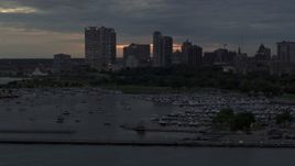 5.7K aerial stock footage of ascending by the marina with a view of the city's skyline at twilight, Downtown Milwaukee, Wisconsin Aerial Stock Footage | DX0002_155_029