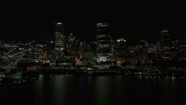 5.7K aerial stock footage view of towering skyscrapers seen from the lake at night, Downtown Milwaukee, Wisconsin Aerial Stock Footage | DX0002_157_041