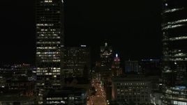 5.7K aerial stock footage reverse view of Wisconsin Avenue and skyscrapers at night, Downtown Milwaukee, Wisconsin Aerial Stock Footage | DX0002_157_050