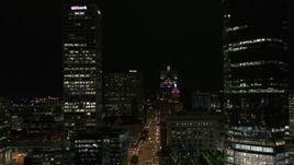 5.7K aerial stock footage fly away from Wisconsin Avenue and skyscrapers at night, Downtown Milwaukee, Wisconsin Aerial Stock Footage | DX0002_157_051
