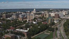 5.7K aerial stock footage ascend over lake with view of of apartment buildings near the capitol dome in Madison, Wisconsin Aerial Stock Footage | DX0002_158_015