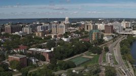 5.7K aerial stock footage reverse view of apartment complexes near the capitol dome in Madison, Wisconsin Aerial Stock Footage | DX0002_158_017