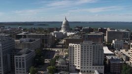 5.7K aerial stock footage of slowly passing the capitol dome surrounded by office buildings, Madison, Wisconsin Aerial Stock Footage | DX0002_158_028