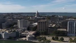 5.7K aerial stock footage reverse view of capitol dome, office buildings, seen from lake, Madison, Wisconsin Aerial Stock Footage | DX0002_158_034
