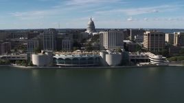 5.7K aerial stock footage of the capitol dome and office buildings, seen while passing convention center, Madison, Wisconsin Aerial Stock Footage | DX0002_158_035
