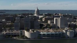 5.7K aerial stock footage of the capitol seen while flying by office buildings and convention center, Madison, Wisconsin Aerial Stock Footage | DX0002_160_002