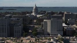5.7K aerial stock footage approach the convention center, focus on capitol behind office buildings, Madison, Wisconsin Aerial Stock Footage | DX0002_160_013