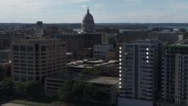 5.7K aerial stock footage focus on capitol and pass by office buildings, Madison, Wisconsin Aerial Stock Footage | DX0002_160_015
