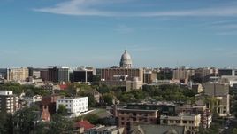 5.7K aerial stock footage of ascending near apartment buildings for view of the capitol building in Madison, Wisconsin Aerial Stock Footage | DX0002_160_020