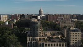 5.7K aerial stock footage of flying by apartment buildings with a view of the capitol building, reveal hotel in Madison, Wisconsin Aerial Stock Footage | DX0002_160_022