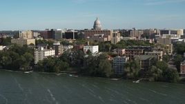 5.7K aerial stock footage focus on the capitol dome while passing lakeside apartment buildings in Madison, Wisconsin Aerial Stock Footage | DX0002_160_025