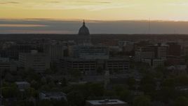 5.7K aerial stock footage of a reverse view of the capitol dome at sunset, Madison, Wisconsin Aerial Stock Footage | DX0002_161_026