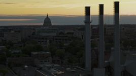 5.7K aerial stock footage flyby the capitol dome at sunset, reveal smoke stacks, Madison, Wisconsin Aerial Stock Footage | DX0002_161_028