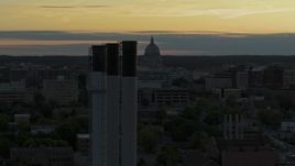 5.7K aerial stock footage flyby the capitol dome at sunset, reveal and orbit smoke stacks, Madison, Wisconsin Aerial Stock Footage | DX0002_161_029