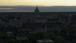 5.7K aerial stock footage approach and flyby the capitol dome at sunset, reveal smoke stacks, Madison, Wisconsin Aerial Stock Footage | DX0002_161_031