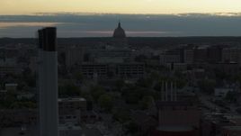 5.7K aerial stock footage of passing the capitol dome at sunset, reveal and orbit smoke stacks, Madison, Wisconsin Aerial Stock Footage | DX0002_162_002
