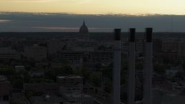 5.7K aerial stock footage flyby smoke stacks with a view of the capitol dome at sunset, Madison, Wisconsin Aerial Stock Footage | DX0002_162_006