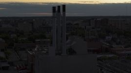 5.7K aerial stock footage of approach and orbit power plant smoke stacks at twilight, Madison, Wisconsin Aerial Stock Footage | DX0002_162_010