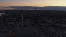 5.7K aerial stock footage the capitol dome seen while passing power plant smoke stacks at twilight, Madison, Wisconsin Aerial Stock Footage | DX0002_162_017