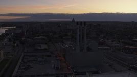 5.7K aerial stock footage focus on capitol dome while passing power plant smoke stacks at twilight, Madison, Wisconsin Aerial Stock Footage | DX0002_162_018