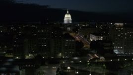 5.7K aerial stock footage the capitol dome while passing downtown buildings at night, Madison, Wisconsin Aerial Stock Footage | DX0002_162_033