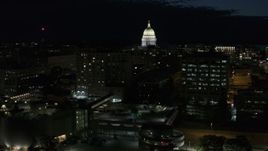 5.7K aerial stock footage fly away from downtown buildings while focused on the capitol at night, Madison, Wisconsin Aerial Stock Footage | DX0002_162_035