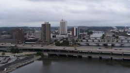 5.7K aerial stock footage of an apartment high-rise and office buildings near bridges over the river, Downtown Cedar Rapids, Iowa Aerial Stock Footage | DX0002_164_001