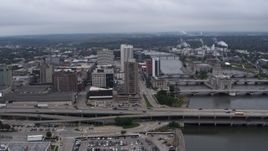 5.7K aerial stock footage flyby and away from an apartment high-rise and office buildings near bridges and river, Downtown Cedar Rapids, Iowa Aerial Stock Footage | DX0002_164_002