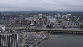 5.7K aerial stock footage slow approach to apartment high-rise and office buildings near bridges and river, Downtown Cedar Rapids, Iowa Aerial Stock Footage | DX0002_164_003