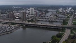 5.7K aerial stock footage a reverse view of bridges spanning the river by Downtown Cedar Rapids, Iowa Aerial Stock Footage | DX0002_164_006