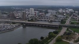 5.7K aerial stock footage of flying by bridges spanning the river by Downtown Cedar Rapids, Iowa Aerial Stock Footage | DX0002_164_007