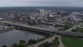 5.7K aerial stock footage approach and flyby bridges spanning the river beside Downtown Cedar Rapids, Iowa Aerial Stock Footage | DX0002_164_008