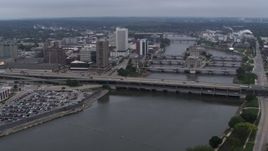 5.7K aerial stock footage fly away from and flyby bridges spanning the river beside Downtown Cedar Rapids, Iowa Aerial Stock Footage | DX0002_164_009