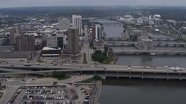5.7K aerial stock footage approach apartment high-rise and bridges spanning the river, Downtown Cedar Rapids, Iowa Aerial Stock Footage | DX0002_164_010
