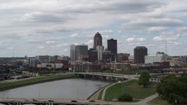 5.7K aerial stock footage ascend from park for view of skyline across the river, Downtown Des Moines, Iowa Aerial Stock Footage | DX0002_165_018