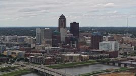 5.7K aerial stock footage of flying by the Cedar River while focused on skyline of Downtown Des Moines, Iowa Aerial Stock Footage | DX0002_165_031