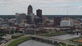 5.7K aerial stock footage of flying by a Cedar River bridge with view of skyline, Downtown Des Moines, Iowa Aerial Stock Footage | DX0002_165_034