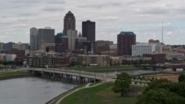 5.7K aerial stock footage of passing by a Cedar River bridge with view of skyline, Downtown Des Moines, Iowa Aerial Stock Footage | DX0002_165_036