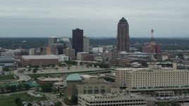5.7K aerial stock footage of a reverse view of the city's skyline and skyscraper in Downtown Des Moines, Iowa, reveal hospital Aerial Stock Footage | DX0002_167_003