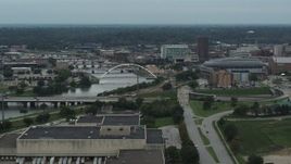5.7K aerial stock footage of bridges over Cedar River by the arena in Downtown Des Moines, Iowa Aerial Stock Footage | DX0002_167_011