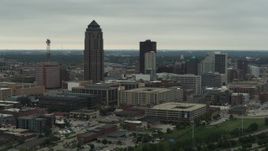 5.7K aerial stock footage flying by a towering skyscraper and office buildings in Downtown Des Moines, Iowa Aerial Stock Footage | DX0002_167_018
