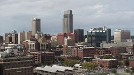 5.7K aerial stock footage of flying by skyscraper and downtown skyline in Downtown Omaha, Nebraska Aerial Stock Footage | DX0002_168_009