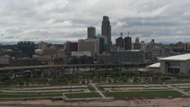 5.7K aerial stock footage of a view of the city skyline from riverfront park, Downtown Omaha, Nebraska Aerial Stock Footage | DX0002_168_018