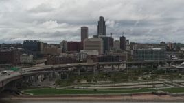 5.7K aerial stock footage of a reverse view of the city skyline from riverfront park, Downtown Omaha, Nebraska Aerial Stock Footage | DX0002_168_019