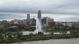 5.7K aerial stock footage passing by a fountain in a park and skyline, Downtown Omaha, Nebraska Aerial Stock Footage | DX0002_169_027