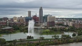 5.7K aerial stock footage of the city's skyline while flying by a park fountain, Downtown Omaha, Nebraska Aerial Stock Footage | DX0002_169_030