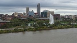 5.7K aerial stock footage of the city's skyline and park fountain seen from river, Downtown Omaha, Nebraska Aerial Stock Footage | DX0002_169_034